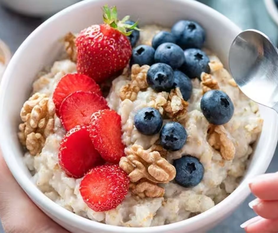 Bowl of oatmeal topped with berries and nuts