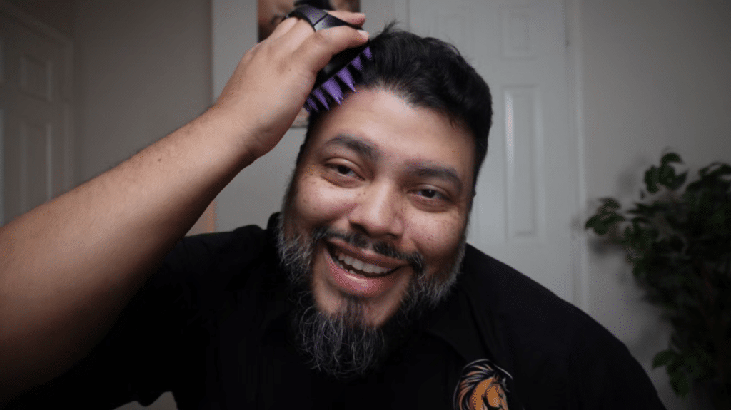 applying Mane Growth Elixir with a scalp massager